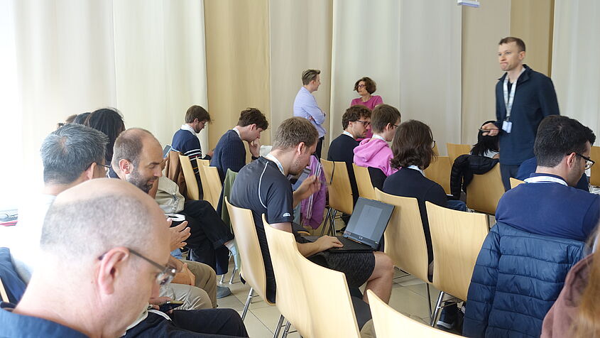 The photo shows some of the workshop participants during a coffee break.
